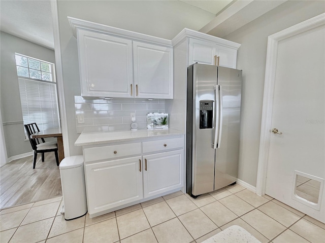 5205 Hammock Cir, Saint Cloud, FL 34771 - kitchen with stainless steel fridge, light countertops, white cabinetry, tasteful backsplash, and light tile patterned floors