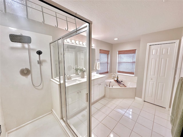 5205 Hammock Cir, Saint Cloud, FL 34771 - bathroom with a stall shower, a garden tub, vanity, a textured ceiling, and tile patterned floors