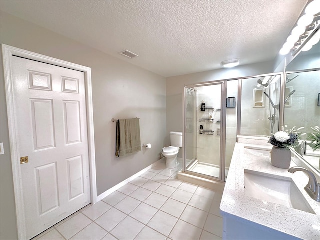 5205 Hammock Cir, Saint Cloud, FL 34771 - full bath with double vanity, a textured ceiling, a shower stall, and tile patterned flooring