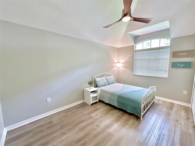 5205 Hammock Cir, Saint Cloud, FL 34771 - bedroom with lofted ceiling, wood finished floors, a textured ceiling, and ceiling fan