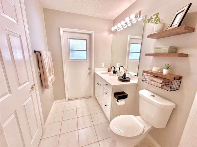 5205 Hammock Cir, Saint Cloud, FL 34771 - bathroom featuring healthy amount of natural light, vanity, a textured ceiling, and tile patterned floors