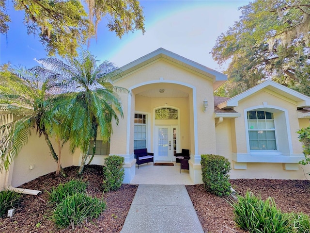 5205 Hammock Cir, Saint Cloud, FL 34771 - doorway to property featuring stucco siding and a porch