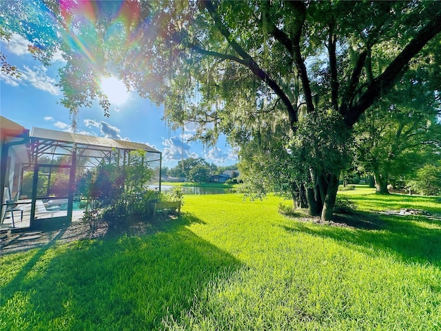 5205 Hammock Cir, Saint Cloud, FL 34771 - view of green lawn featuring glass enclosure and a water view