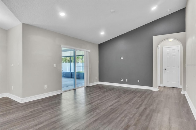 1031 Seneca Trl, Saint Cloud, FL 34772 - unfurnished room with wood finished floors, recessed lighting, and vaulted ceiling