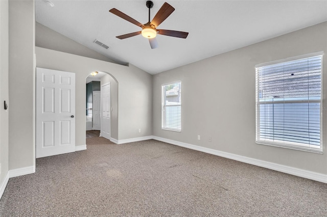 1031 Seneca Trl, Saint Cloud, FL 34772 - carpeted empty room featuring arched walkways, a ceiling fan, and vaulted ceiling