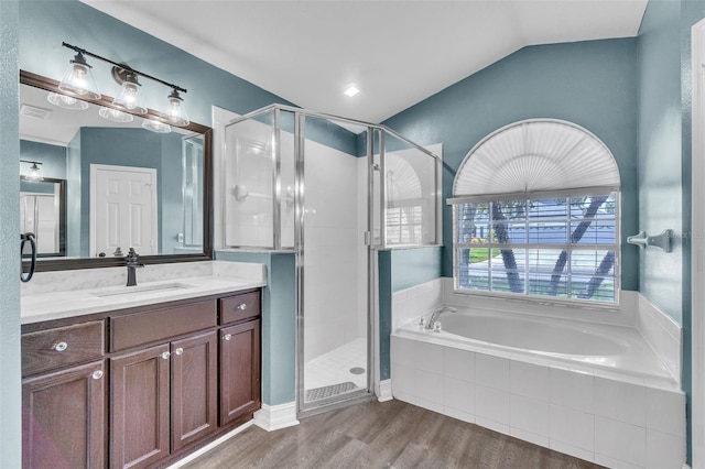 1031 Seneca Trl, Saint Cloud, FL 34772 - bathroom featuring a garden tub, vanity, a shower stall, wood finished floors, and lofted ceiling