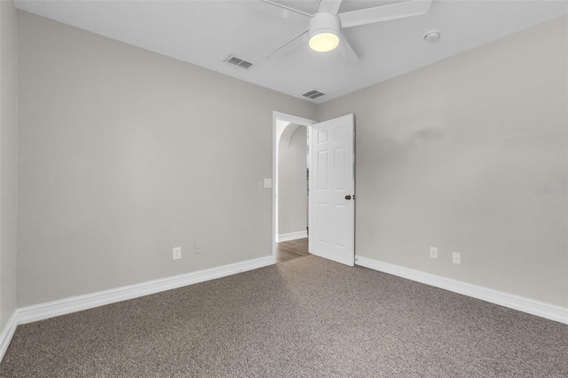 1031 Seneca Trl, Saint Cloud, FL 34772 - carpeted empty room featuring a ceiling fan, arched walkways, and a smoke detector