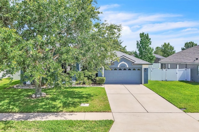 1031 Seneca Trl, Saint Cloud, FL 34772 - view of front of home featuring driveway, a gate, an attached garage, stucco siding, and roof with shingles