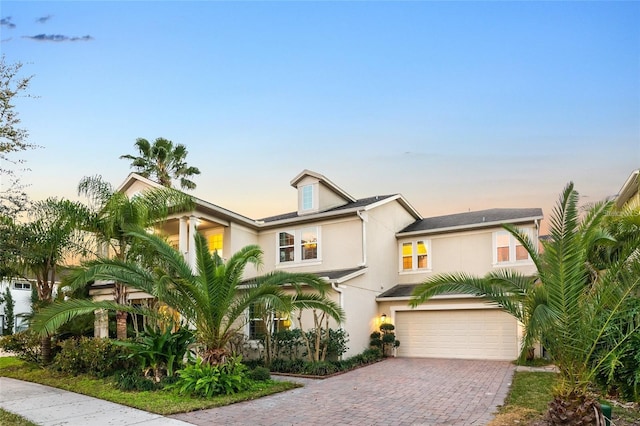 5552 Remsen Cay Ln, Windermere, FL 34786 - view of front of property featuring a garage, stucco siding, and decorative driveway
