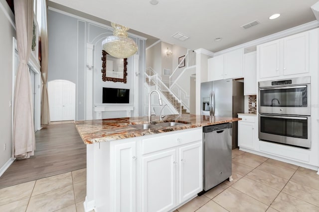 5552 Remsen Cay Ln, Windermere, FL 34786 - kitchen featuring stainless steel appliances, light tile patterned flooring, light stone countertops, white cabinets, and recessed lighting