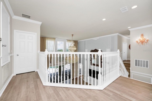 5552 Remsen Cay Ln, Windermere, FL 34786 - hallway with an upstairs landing, a chandelier, ornamental molding, wood finished floors, and recessed lighting
