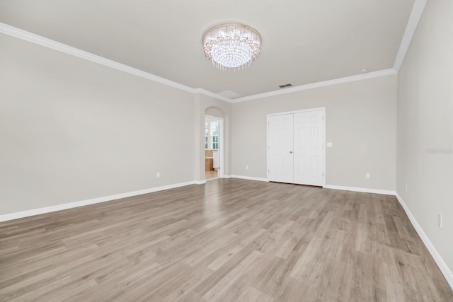 5552 Remsen Cay Ln, Windermere, FL 34786 - unfurnished bedroom featuring a chandelier, light wood finished floors, arched walkways, ornamental molding, and a closet