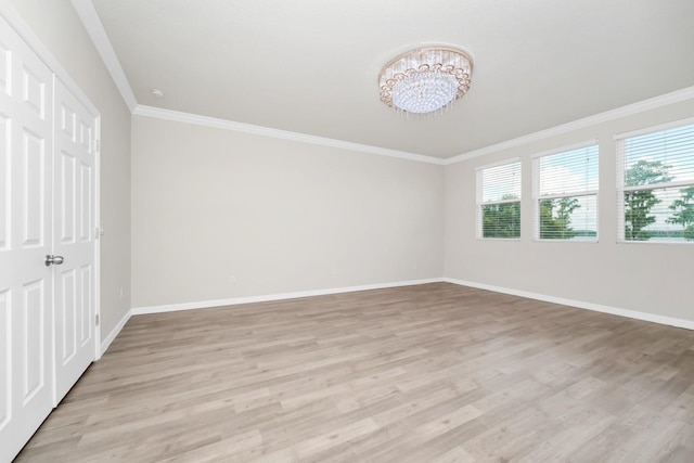 5552 Remsen Cay Ln, Windermere, FL 34786 - unfurnished bedroom featuring a chandelier, light wood-style floors, and ornamental molding