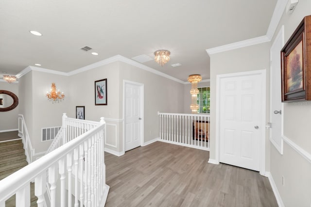 5552 Remsen Cay Ln, Windermere, FL 34786 - hall with a chandelier, an upstairs landing, light wood-style flooring, recessed lighting, and crown molding