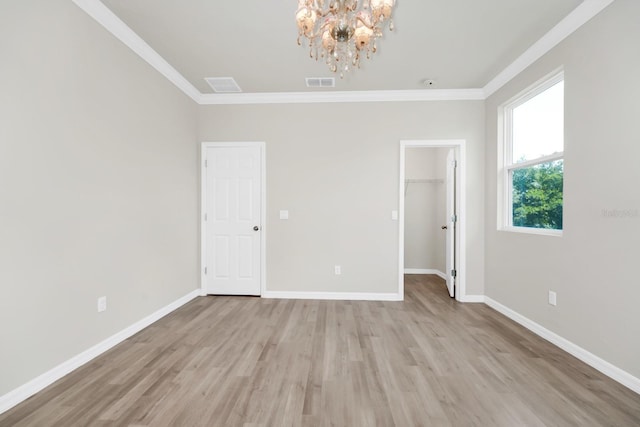5552 Remsen Cay Ln, Windermere, FL 34786 - spare room featuring a chandelier, crown molding, and light wood finished floors