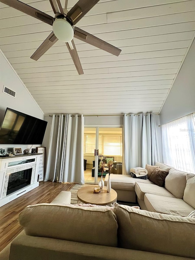 1034 Villa Ln Unit 18, Apopka, FL 32712 - living room with lofted ceiling, ceiling fan, wooden ceiling, a fireplace, and wood finished floors