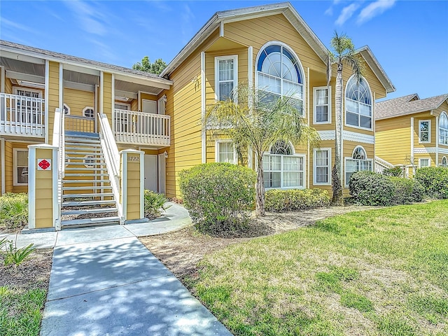 8722 Rockingham Ter Unit B, Kissimmee, FL 34747 - view of front of property featuring stairway and a front lawn