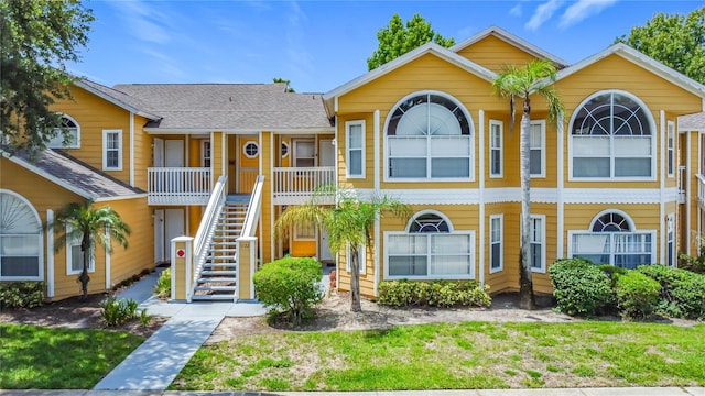 8722 Rockingham Ter Unit B, Kissimmee, FL 34747 - view of front of house with stairs, covered porch, and roof with shingles