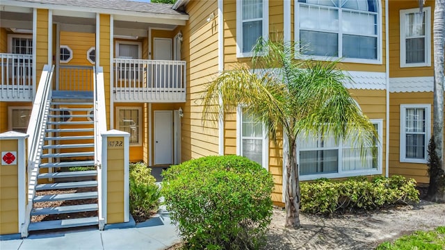 8722 Rockingham Ter Unit B, Kissimmee, FL 34747 - view of exterior entry featuring a shingled roof