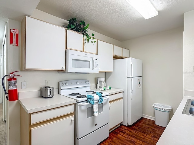 8722 Rockingham Ter Unit B, Kissimmee, FL 34747 - kitchen with white appliances, light countertops, dark wood-style flooring, white cabinetry, and a textured ceiling
