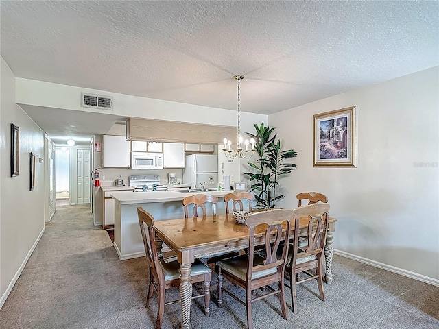 8722 Rockingham Ter Unit B, Kissimmee, FL 34747 - carpeted dining room with a chandelier and a textured ceiling