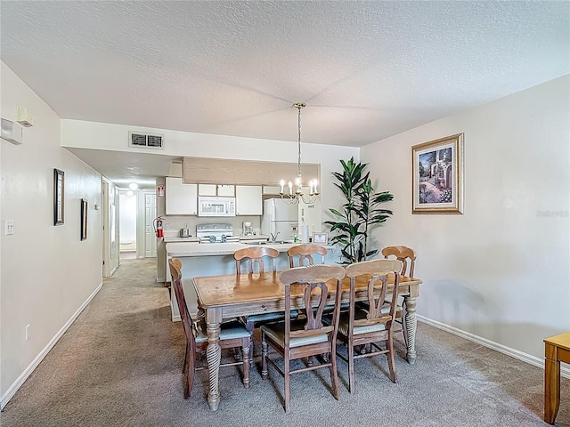 8722 Rockingham Ter Unit B, Kissimmee, FL 34747 - dining space with a chandelier, light colored carpet, and a textured ceiling