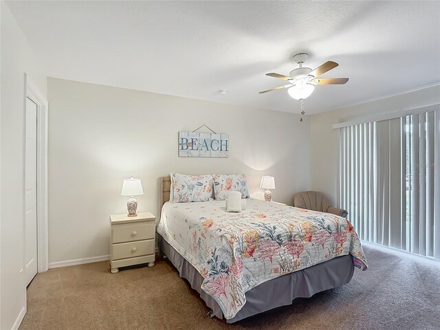 8722 Rockingham Ter Unit B, Kissimmee, FL 34747 - bedroom featuring multiple windows, light carpet, and ceiling fan