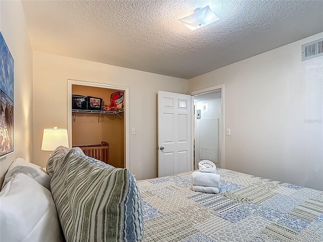 8722 Rockingham Ter Unit B, Kissimmee, FL 34747 - bedroom featuring a textured ceiling, a closet, and a spacious closet