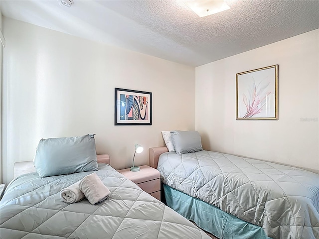 8722 Rockingham Ter Unit B, Kissimmee, FL 34747 - bedroom featuring a textured ceiling