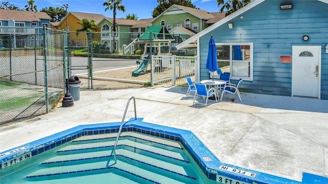 8722 Rockingham Ter Unit B, Kissimmee, FL 34747 - view of pool with a community hot tub, a patio area, a gate, and a residential view