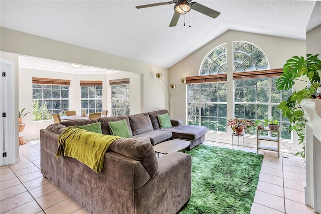 698 Roaring Dr Unit 382, Altamonte Springs, FL 32714 - living room featuring a ceiling fan, plenty of natural light, light tile patterned floors, vaulted ceiling, and a textured ceiling