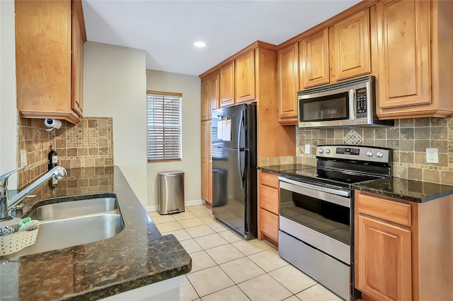 698 Roaring Dr Unit 382, Altamonte Springs, FL 32714 - kitchen with stainless steel appliances, light tile patterned floors, tasteful backsplash, dark stone counters, and recessed lighting