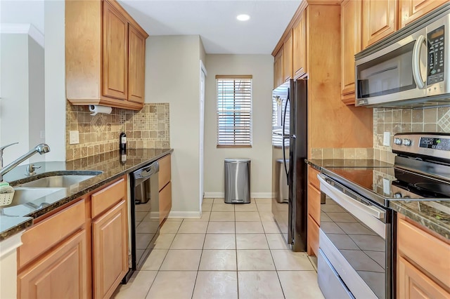 698 Roaring Dr Unit 382, Altamonte Springs, FL 32714 - kitchen featuring stainless steel appliances, decorative backsplash, light tile patterned floors, dark stone countertops, and recessed lighting