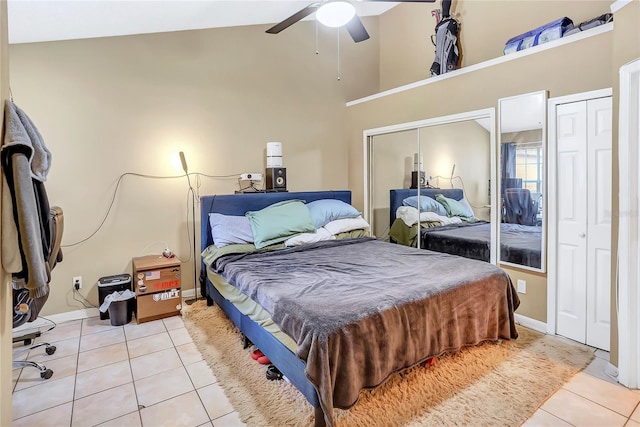 698 Roaring Dr Unit 382, Altamonte Springs, FL 32714 - bedroom with light tile patterned floors, high vaulted ceiling, two closets, and ceiling fan
