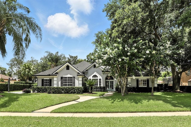 2890 Wild Ginger Ct, Winter Park, FL 32792 - ranch-style house with stucco siding, a front yard, and french doors