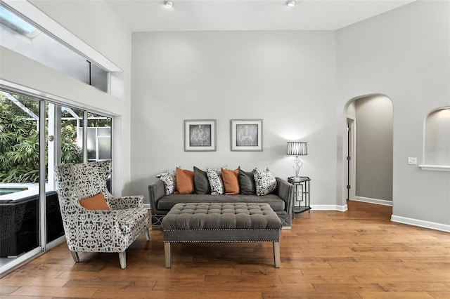 2890 Wild Ginger Ct, Winter Park, FL 32792 - living area with a high ceiling, arched walkways, and wood finished floors