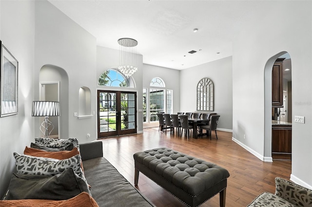 2890 Wild Ginger Ct, Winter Park, FL 32792 - living area with arched walkways, dark wood finished floors, and a towering ceiling