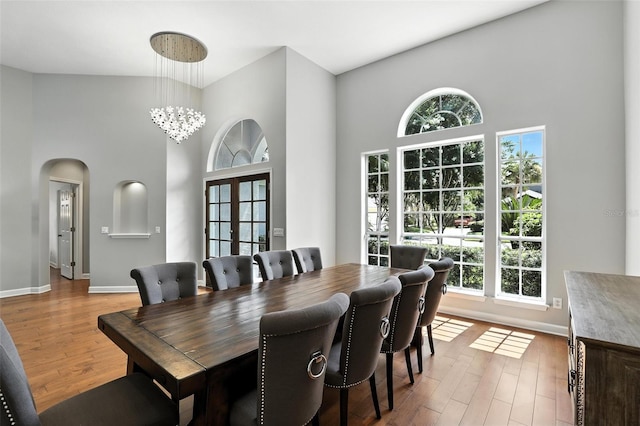 2890 Wild Ginger Ct, Winter Park, FL 32792 - dining room with a high ceiling, arched walkways, and wood finished floors