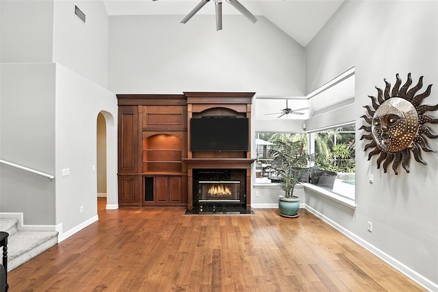 2890 Wild Ginger Ct, Winter Park, FL 32792 - living area with ceiling fan, high vaulted ceiling, wood finished floors, a fireplace, and arched walkways
