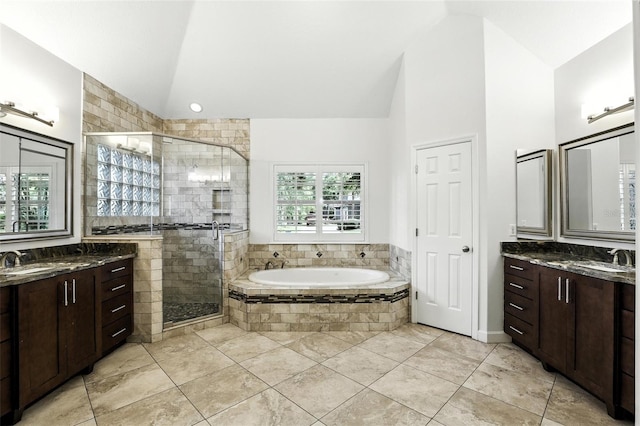 2890 Wild Ginger Ct, Winter Park, FL 32792 - bathroom with two vanities, a shower stall, a garden tub, high vaulted ceiling, and tile patterned floors