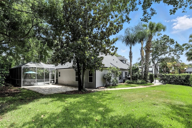 2890 Wild Ginger Ct, Winter Park, FL 32792 - view of grassy yard featuring a patio and glass enclosure