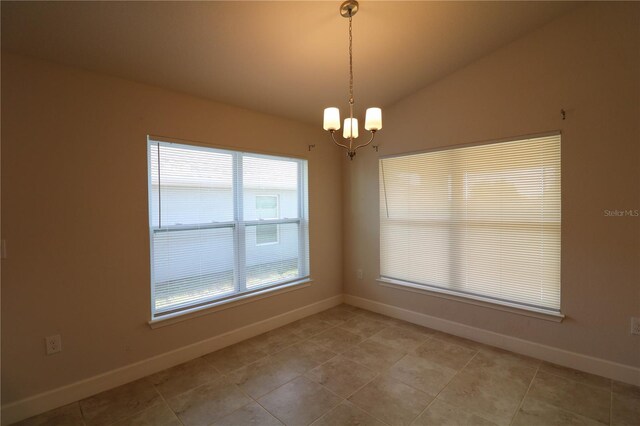 1105 Citrus Landings Blvd, Davenport, FL 33837 - empty room featuring a chandelier, lofted ceiling, and light tile patterned floors