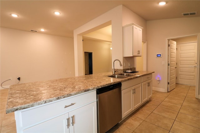 1105 Citrus Landings Blvd, Davenport, FL 33837 - kitchen with stainless steel dishwasher, white cabinetry, light tile patterned flooring, recessed lighting, and light stone counters