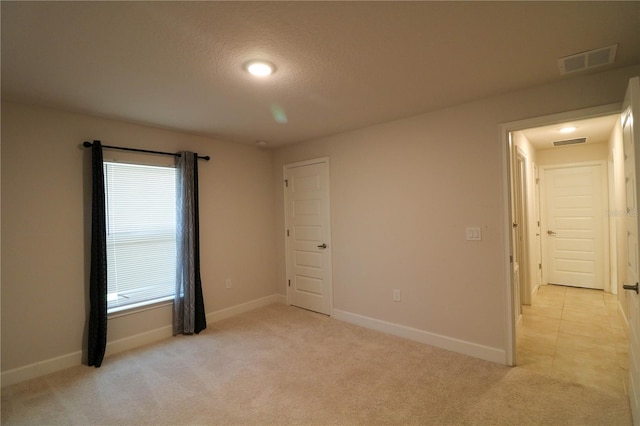 1105 Citrus Landings Blvd, Davenport, FL 33837 - unfurnished bedroom with light carpet, a textured ceiling, and recessed lighting