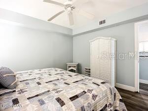 2055 S Atlantic Ave Unit 505, Daytona Beach, FL 32118 - bedroom featuring dark wood finished floors and a ceiling fan