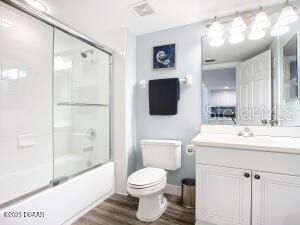 2055 S Atlantic Ave Unit 505, Daytona Beach, FL 32118 - full bath featuring vanity, wood finished floors, and combined bath / shower with glass door