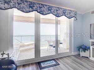 2055 S Atlantic Ave Unit 505, Daytona Beach, FL 32118 - doorway to outside with wood finished floors and a water view