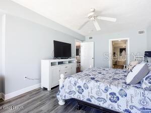 2055 S Atlantic Ave Unit 505, Daytona Beach, FL 32118 - bedroom featuring dark wood finished floors and a ceiling fan