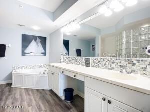 2055 S Atlantic Ave Unit 505, Daytona Beach, FL 32118 - full bath with double vanity, tasteful backsplash, a bath, and wood finished floors