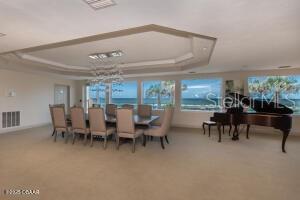 2055 S Atlantic Ave Unit 505, Daytona Beach, FL 32118 - carpeted dining area featuring a tray ceiling